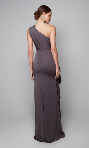 Long one shoulder side ruffle gown with ruching detail, a closed back, and train.