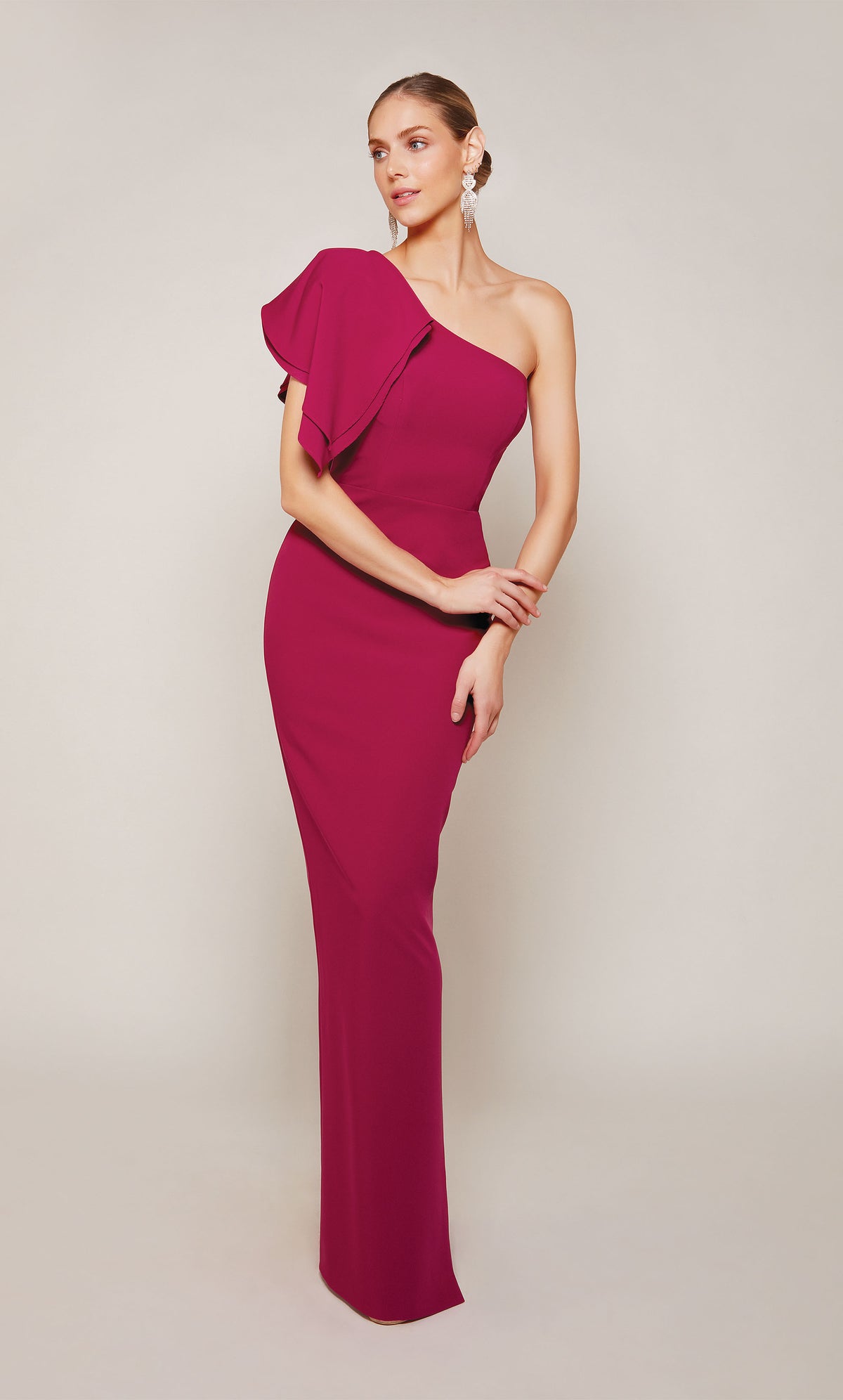 A sophisticated one-shoulder ruffle dress with a zip-up back and a gorgeous ruffle on the right shoulder in a vibrant red color called sparkling grape. This ALYCE Paris designer gown is perfect for a formal evening wedding or black tie event.