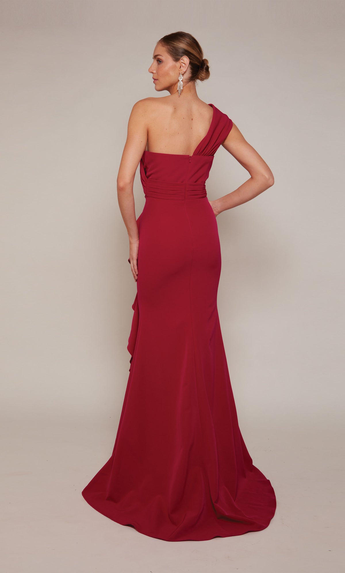 A raspberry pink colored one shoulder evening gown with a zip-up back and a slight train.