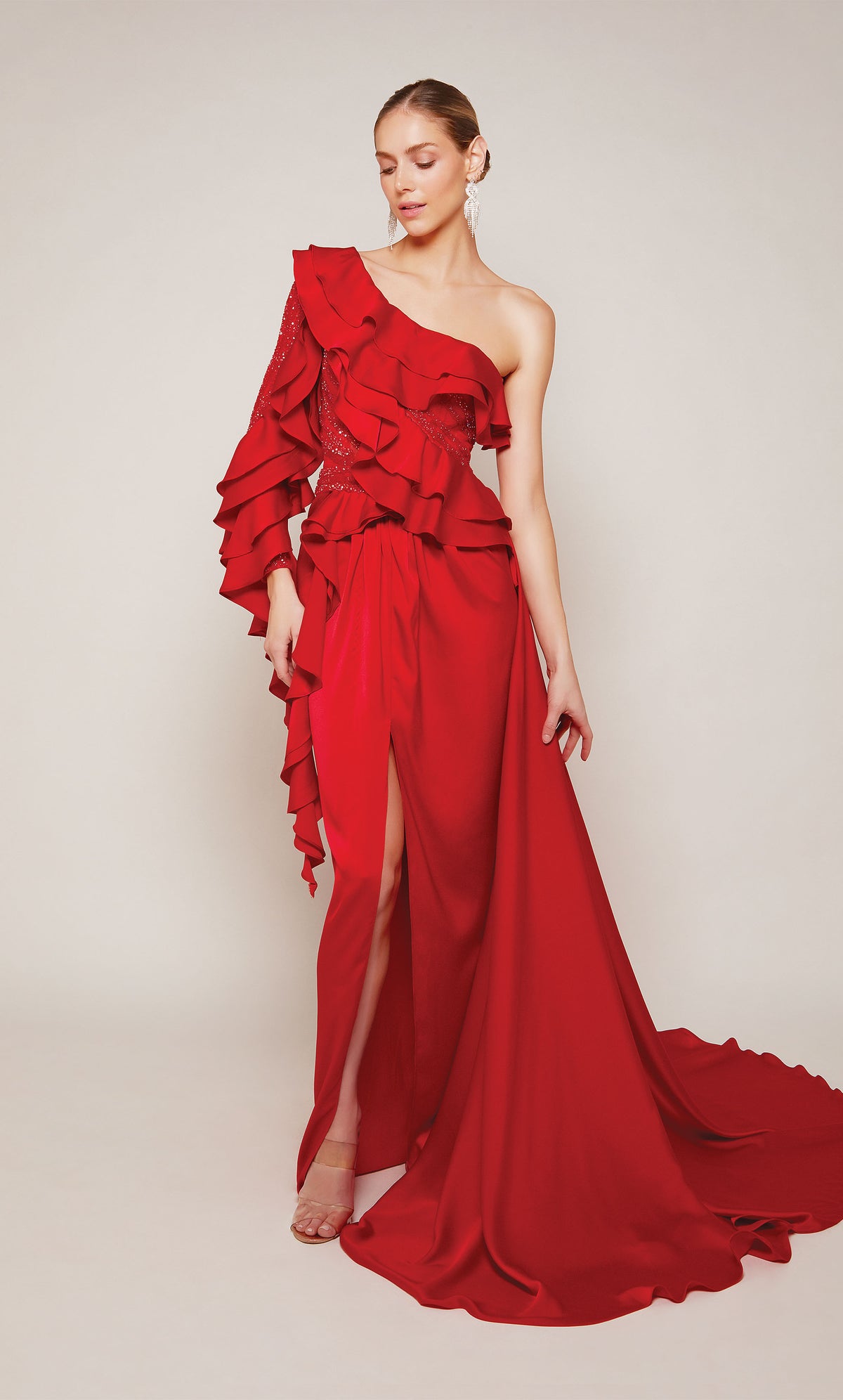A one shoulder ruffle dress with a front slit and dramatic train in red satin.