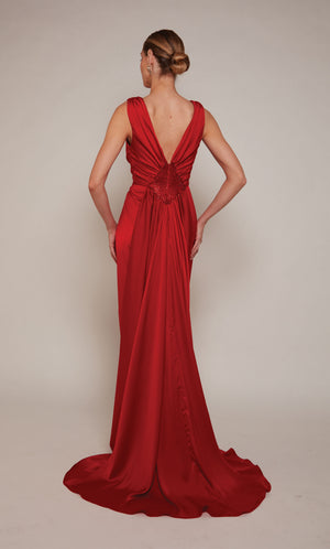 A sleeveless, red satin wedding guest dress with a V-neckline and front slit.