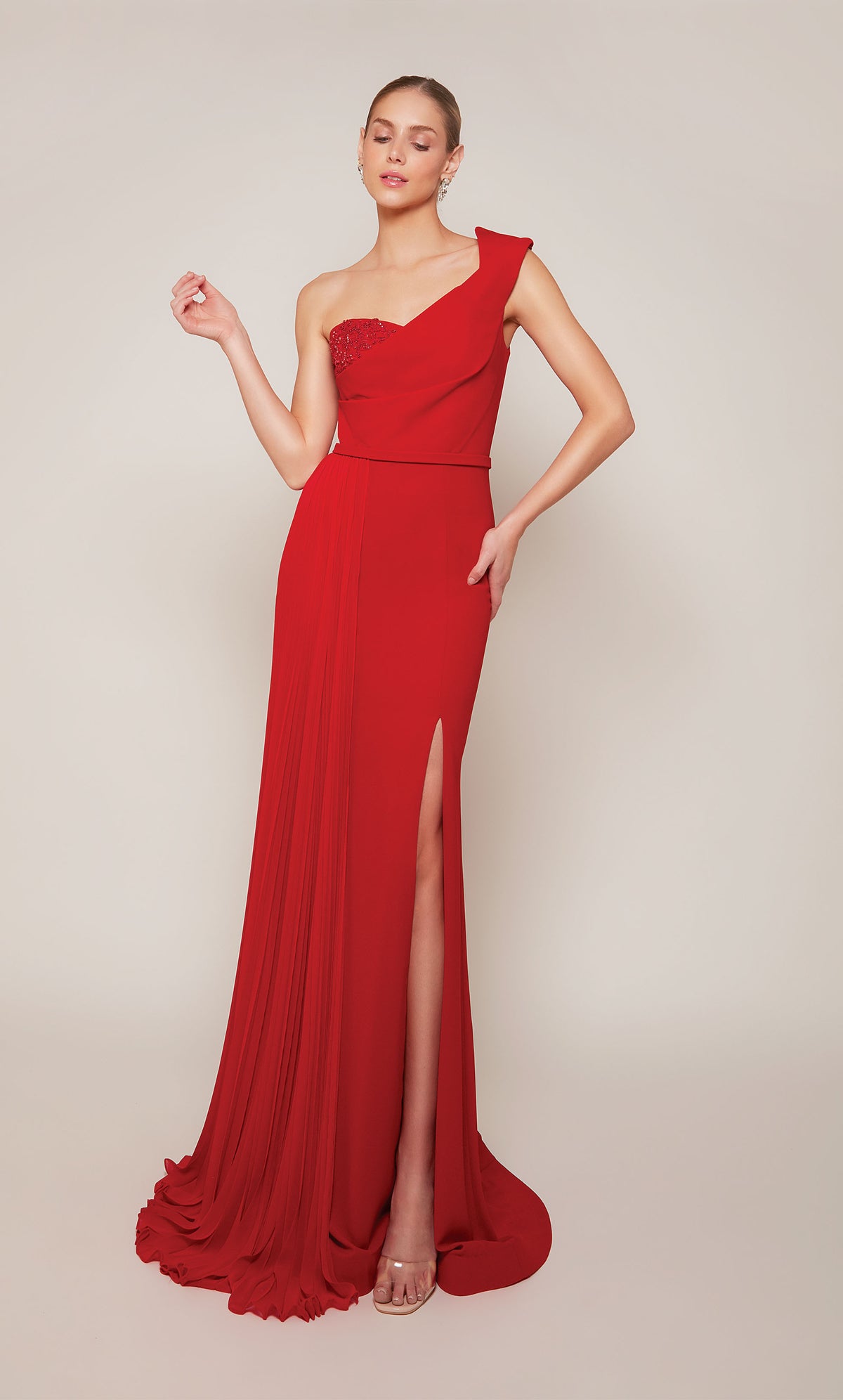 A long formal dress with a one shoulder neckline and side slit in a vibrant red.