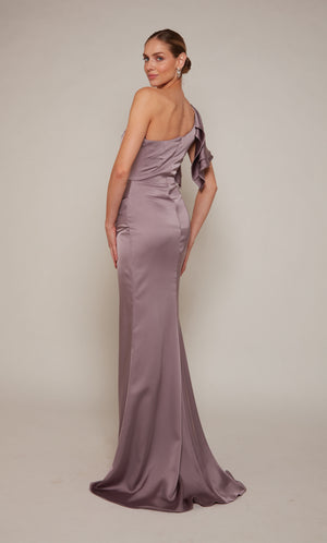 A satin, one shoulder ruffle dress with a zip-up back closure and a slight train in a dusty purple looking color called smoke.