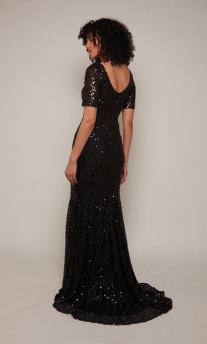 A classic black mother of the bride dress with a U-shaped back, short sleeves, and train crafted in a mesh sequin fabric.