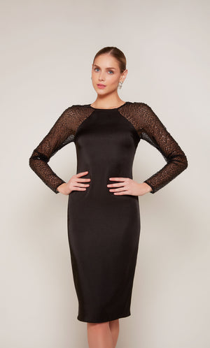 A black satin knee length cocktail dress with long mesh sequin sleeves.