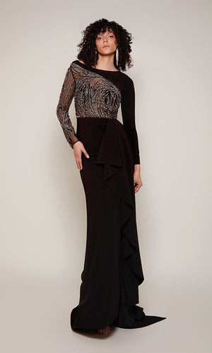 A long sleeve evening gown with a sheer, embellished bodice and sleeve and a cascading ruffle in classic black with silver accents.