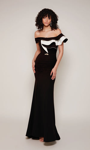 A black and white evening gown with an off-the-shoulder neckline and ruffle bodice. In addition, the dress has a faux belt at the waistline and a slight train.