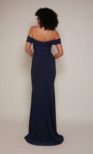 A navy evening gown with an off the shoulder neckline and fit an flare silhouette and a slight train. The dress was crafted from a gorgeous Italian Jersey fabric.