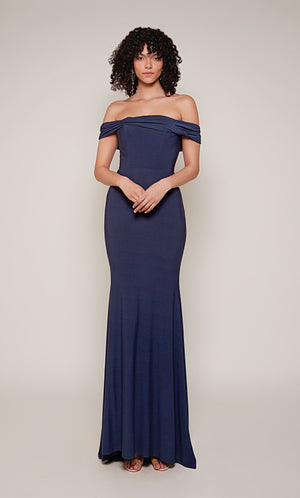 A navy evening gown with an off the shoulder neckline and fit an flare silhouette. The dress was crafted from a gorgeous Italian Jersey fabric.