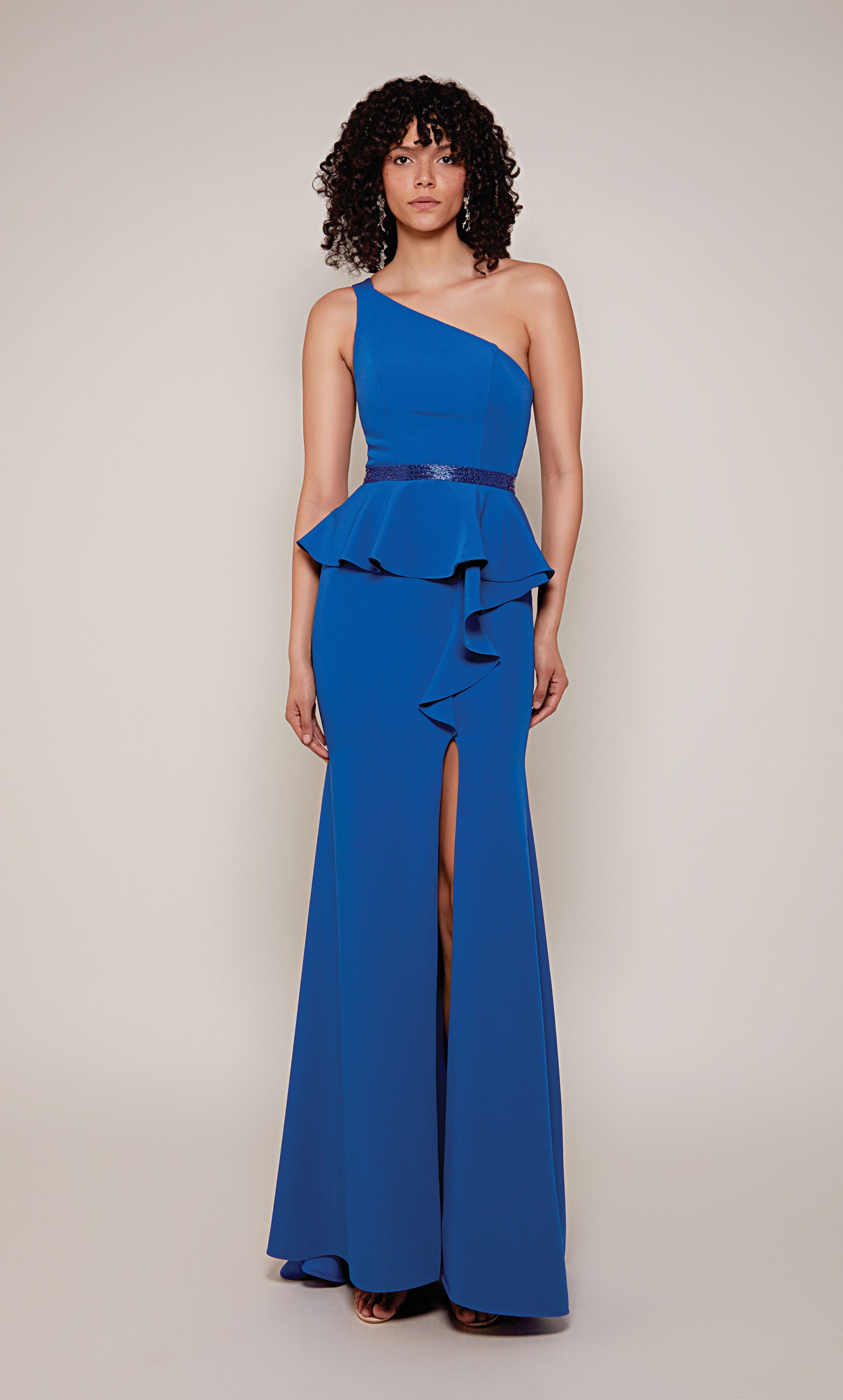 A royal blue, one shoulder mother of the bride dress with a faux beaded belt, peplum bodice, side ruffle, and side slit.