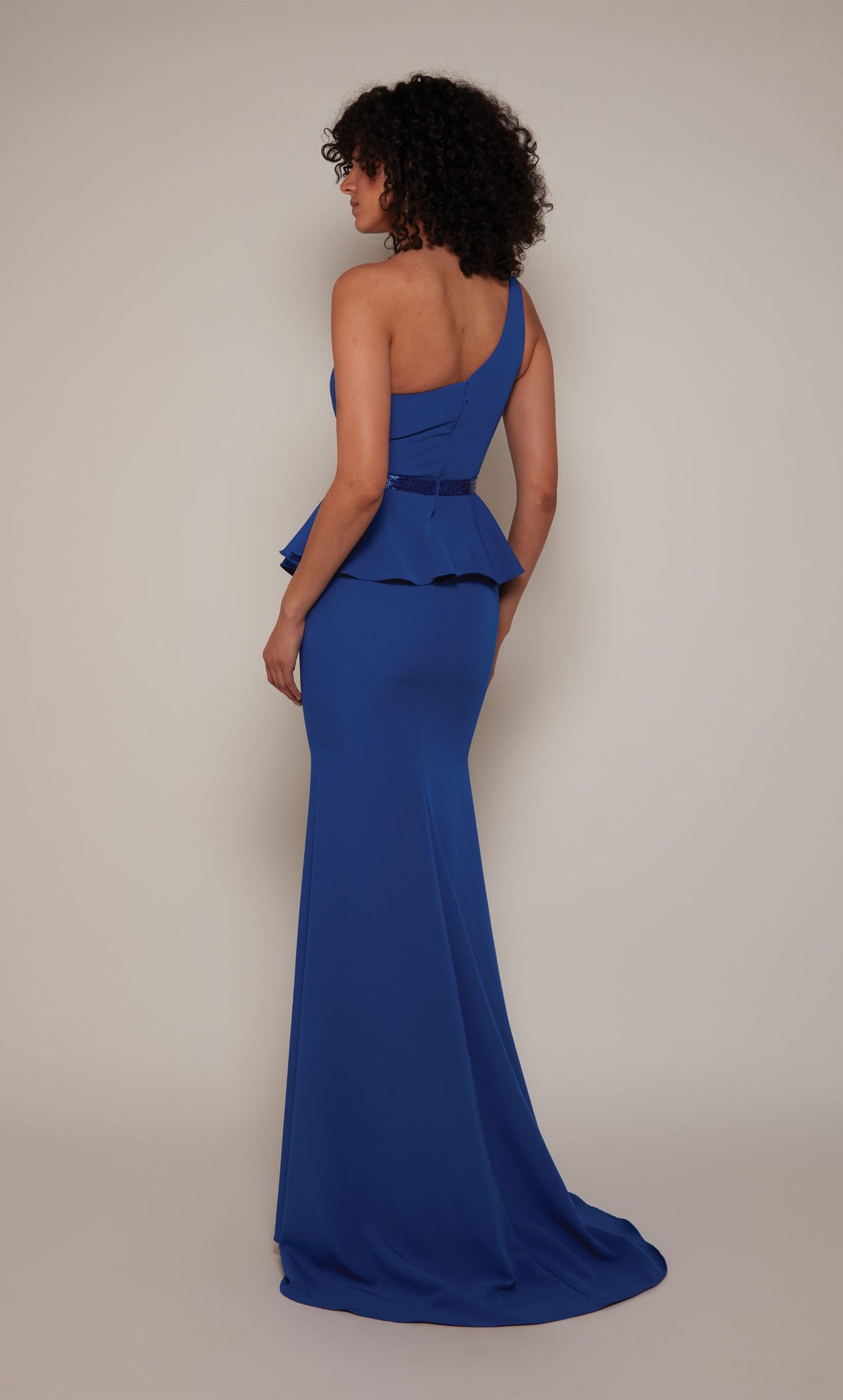 A royal blue, one shoulder mother of the bride dress with a faux beaded belt, peplum bodice, and a slight train.