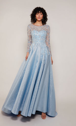 A french blue A-line mother of the bride gown with long sleeves and an illusion semi-sweetheart neckline. The bodice of the dress has a beautiful embellished tulle overlay.