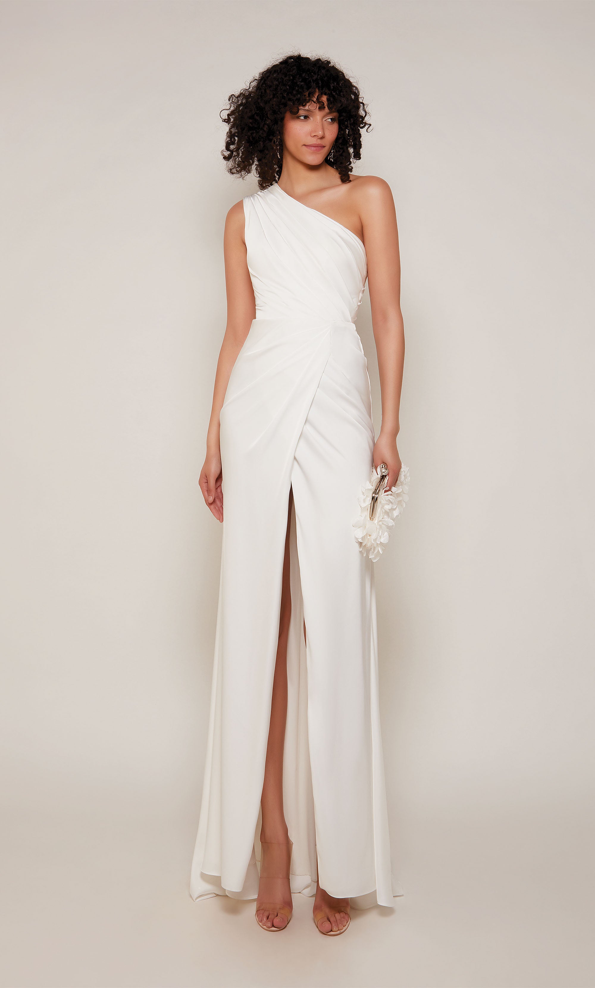An elegant, satin one shoulder gown with ruching detail and front slit, in the color diamond white.