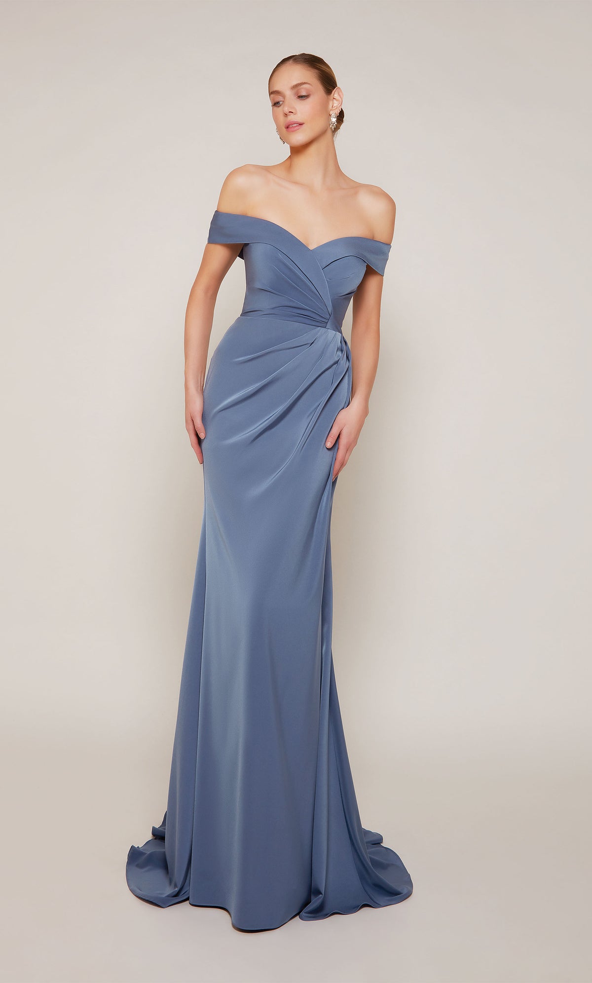 A sophisticated, off-the-shoulder wedding guest dress with a pleated zipper back and train in dark french blue.