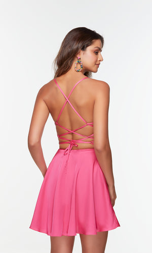 Short hot pink dress with a lace up back and pockets.