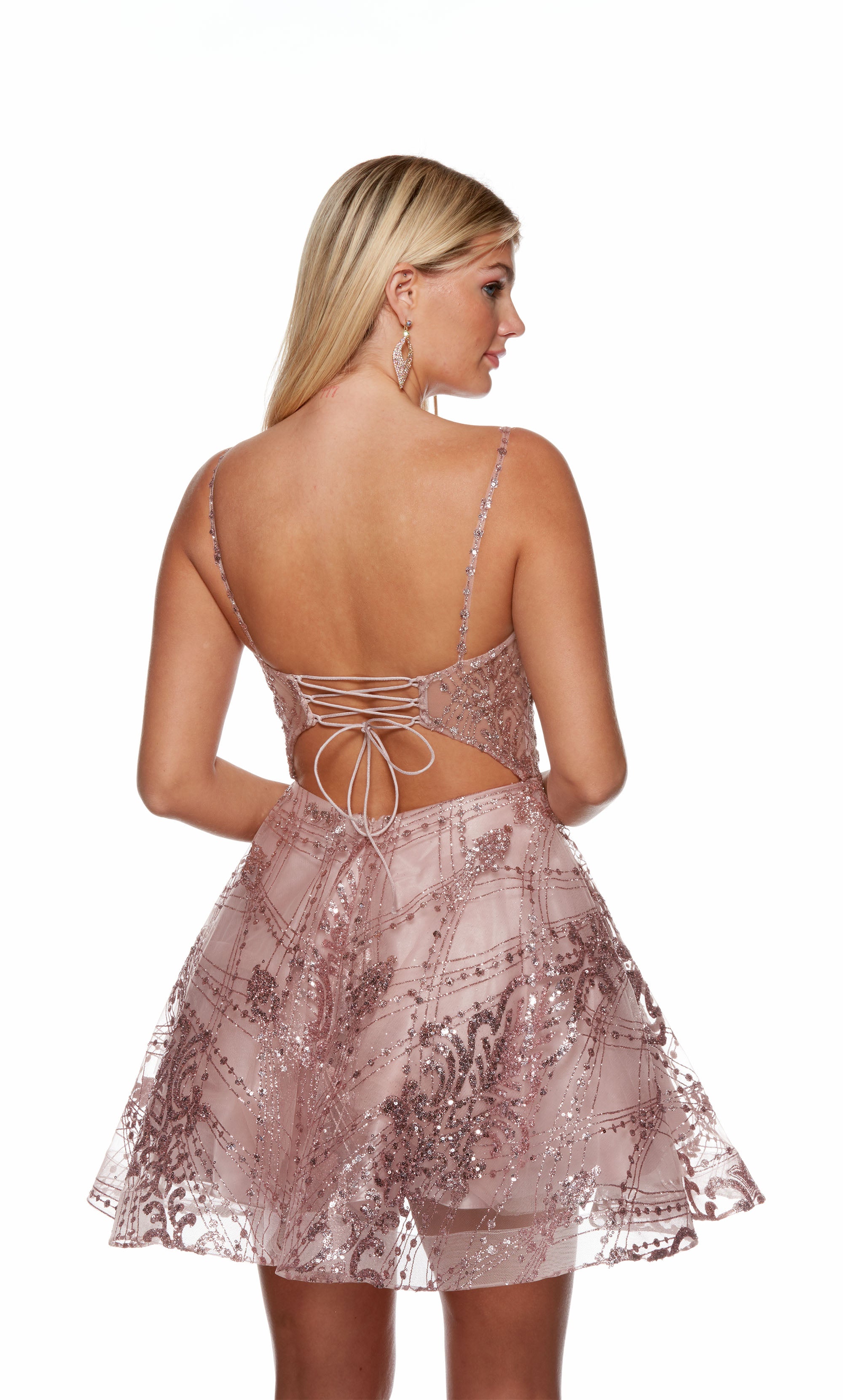 A scoop neck, pink-colored short party dress featuring a beautiful, glitter embellished floral design, and a strappy, open back.