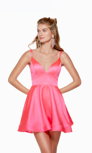 A V-neck, short satin homecoming dress with double spaghetti straps and a strappy, lace-up back in the color barbie pink. This dress is from our latest collection of gorgeous designer dresses by ALYCE Paris.
