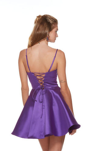 A purple, scooped neck short homecoming dress featuring spagetti straps, a fitted bodice and a flared A-line skirt.