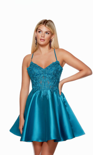 A teal blue, V neck corset dress with a sheer lace bodice and a flared A-line skirt. This dress is from our latest collection of gorgeous designer dresses by ALYCE Paris.