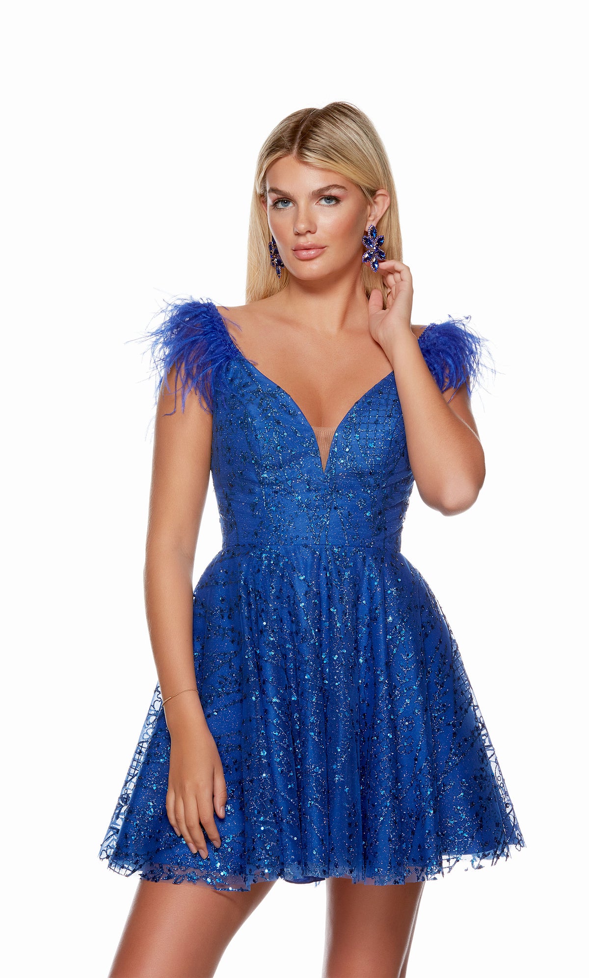 A royal blue, glitter tulle homecoming dress with a plunging neckline, open back and featherd cap sleeve.