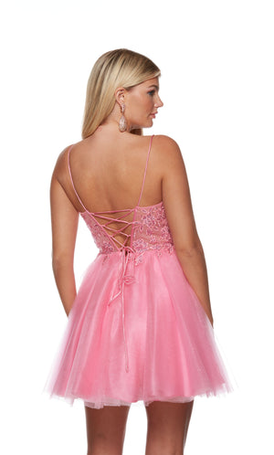 A romantic short prom dress in light pink. The dress has a lace up back and a lace overlay on the bodice, adorned with delicate floral appliques. The skirt is made of multi layered glitter tulle for the perfect touch of sparkle.