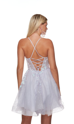 A playful, tulle corset dress in a soft pastel shade, adorned with floral appliques for a whimsical touch. The back is lace-up for a perfect fit.
