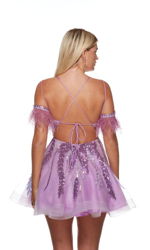 A fun and flouncy A-line dress with a strappy open back, adorned with feather trim and multi-colored sequins for a touch of sparkle. The color is a vibrant lilac purple.
