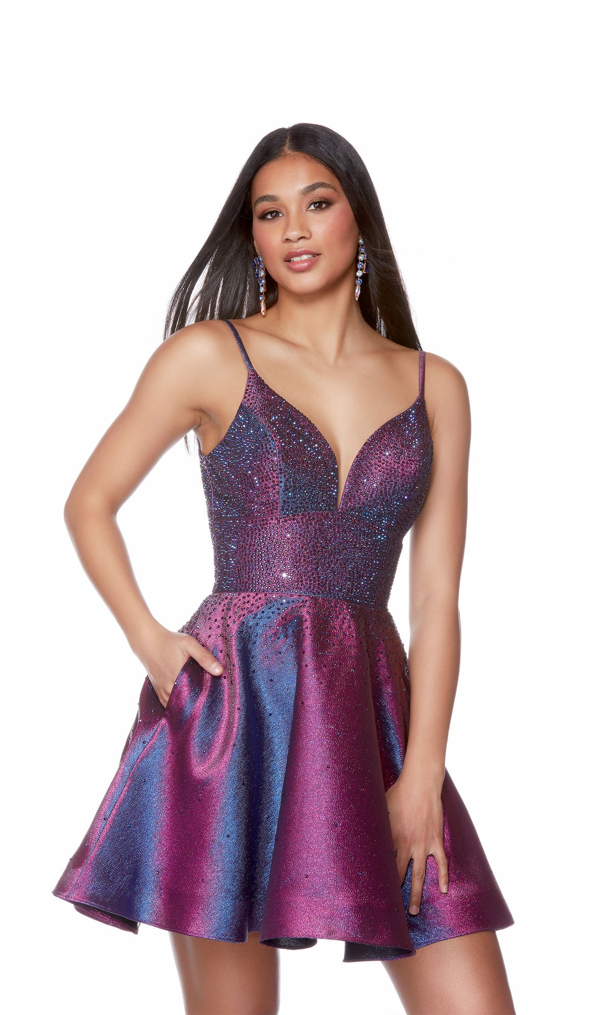 A sparkly metallic short homecoming dress boasting a plunging neckline, jewel embellished bodice, and a flirty flared skirt. The color is an iridescent blue-ish purple called blueberry.