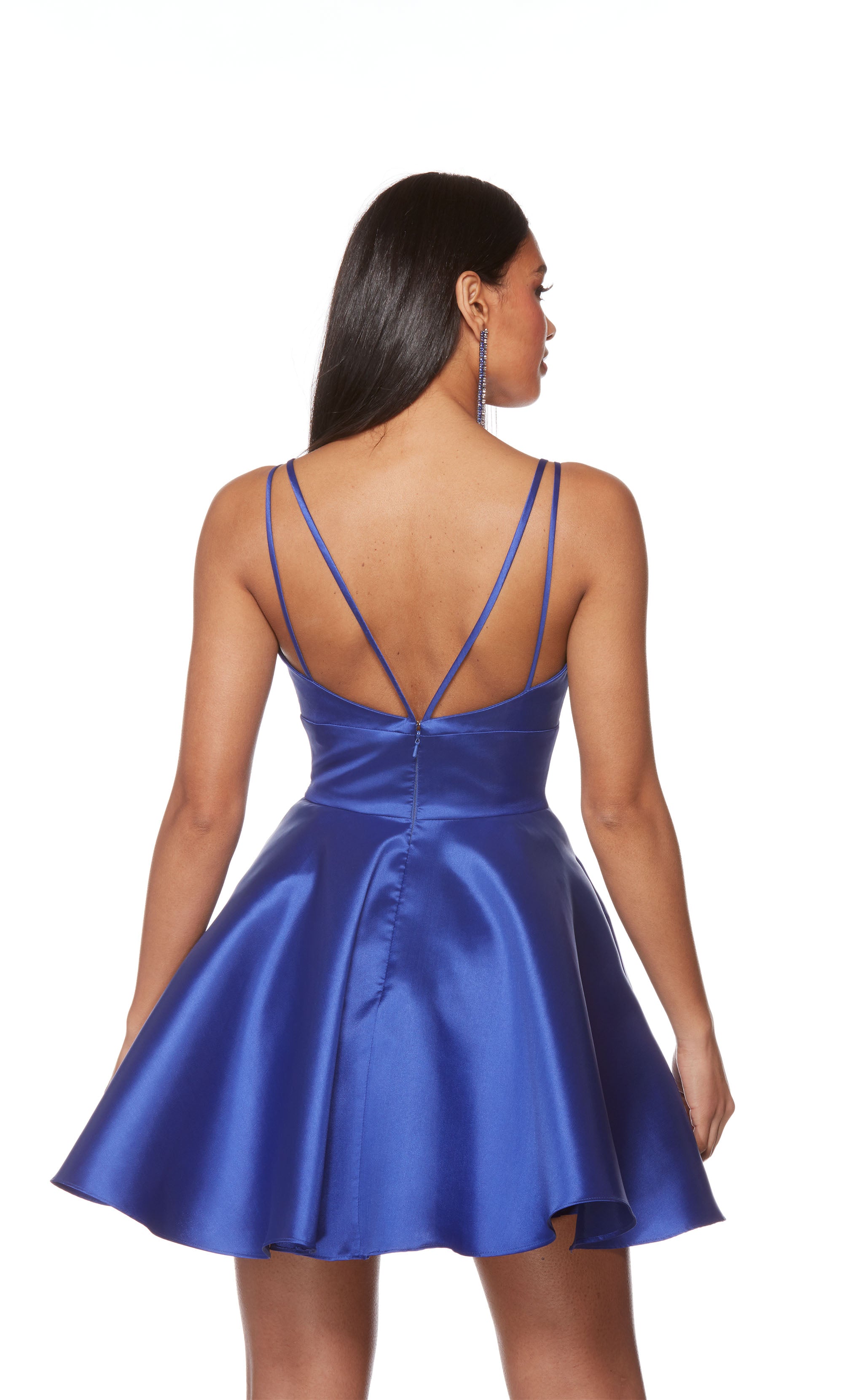 A royal blue flared homecoming dress featuring a soft V-neckline, spaghetti straps, and a full skirt. The dress was created from a luminous Mikado fabric. 