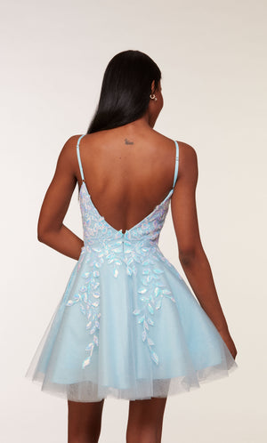 A charming light blue homecoming dress with an open V-back, delicate spaghetti straps, and a flared skirt, showcasing a soft and feminine aesthetic.
