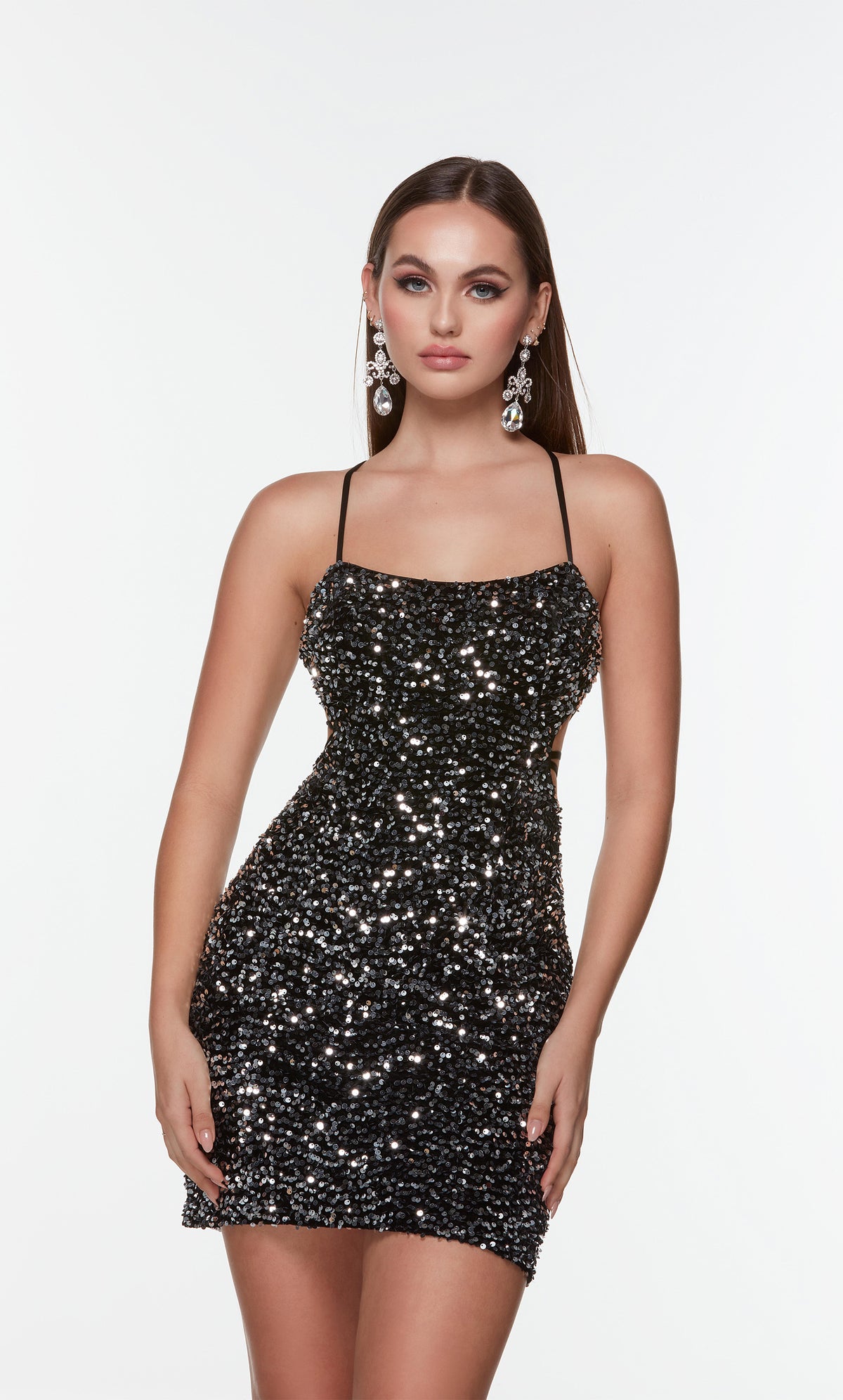 Black and silver sequin mini dress with side cutouts and a scoop neckline. 