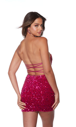 A strapless, vibrant pink sequin homecoming dress with a strappy lace-up back.
