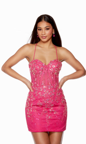 A striking electric fuchsia-colored short corset dress highlighting a sweetheart neckline and sheer bodice. The lace overlay and sequin detailing add the perfect touch to finish off the look.