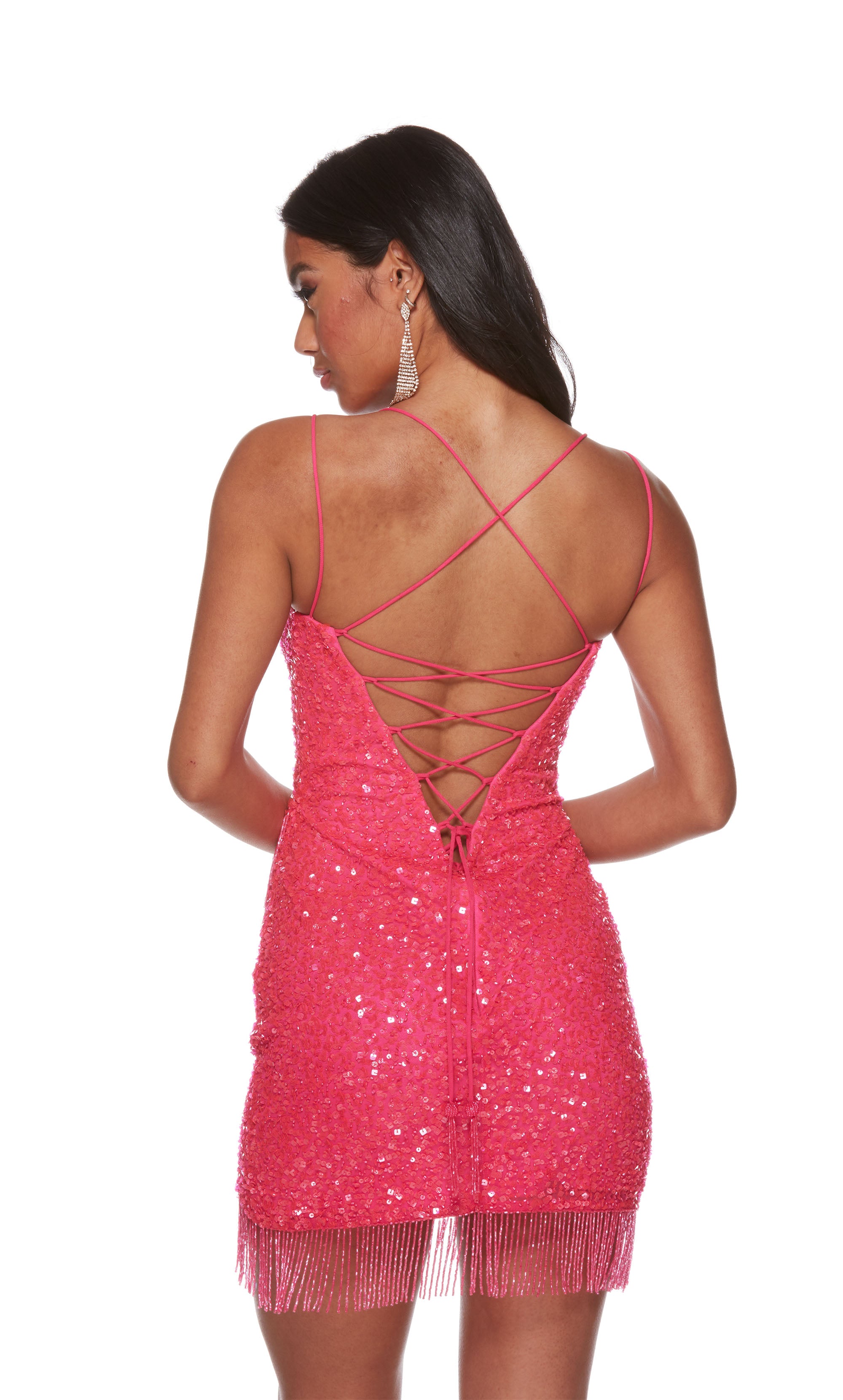 A glamorous electric fuchsia short formal dress dress with a straight across neckline, and dual thin spaghetti straps. Sparkly sequins and a  fringed, asymmetrical hem add a playful, flirtatious vibe to the look.