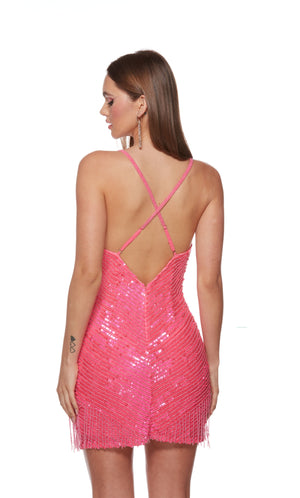 A barbie pink, fully sequin embellished short cocktail dress with a V-neckline and fringed hem. The criss-cross straps on the back of the dress are adjustable for the perfect fit.