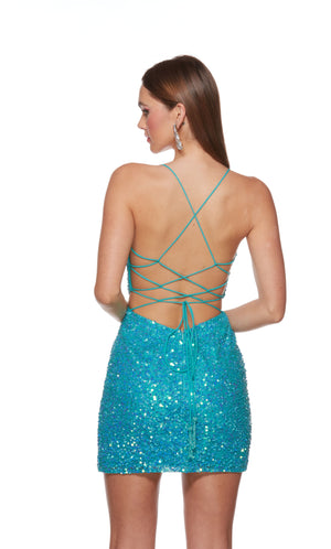 A short sparkly sequin dress with a strappy open back, cut-out sides, and a thigh-high hemline in the color caribbean blue.