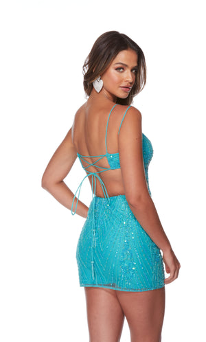 A hand-beaded shimmery mini dress with a lace-up back, side cut-outs, and a fitted silhouette in carribbean blue.