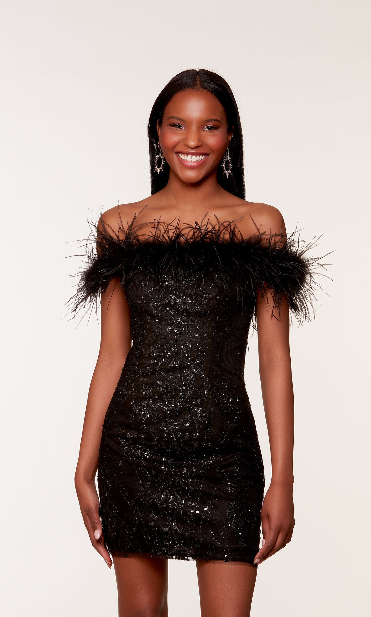A little black dress with a feather-trimmed off-the-shoulder neckline, created from a shimmery, glitter tulle fabric by designer, ALYCE Paris