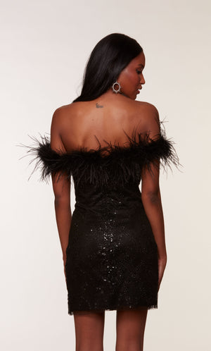 A little black dress with a feather-trimmed off-the-shoulder neckline, created from a shimmery, glitter tulle fabric by designer, ALYCE Paris