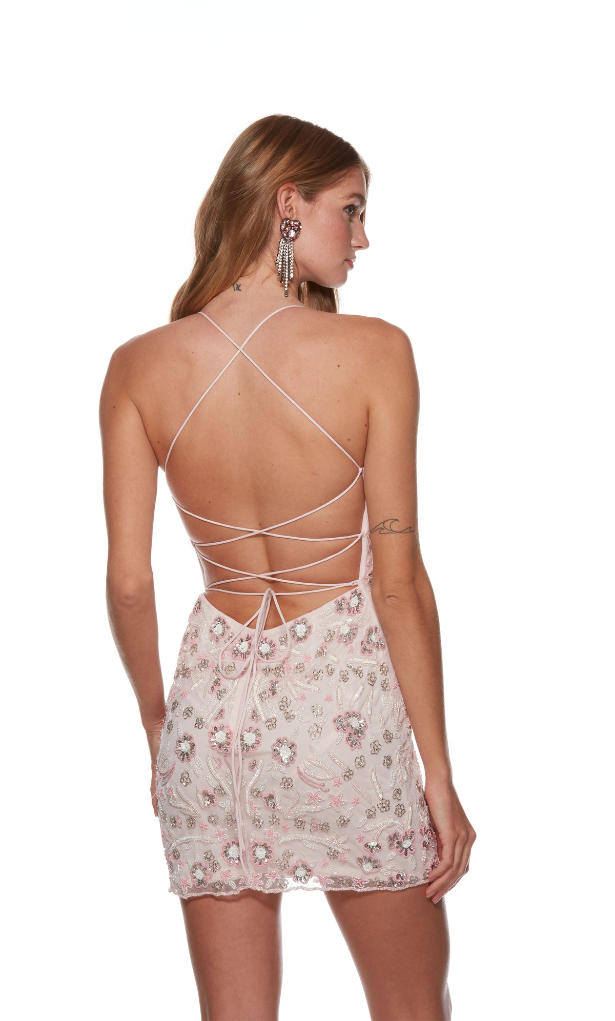 A rosewater pink V-neck short homecoming dress beautifully hand beaded in a boho floral pattern, crafted from pink, silver, and white beads. The back of the dress has a thin strap lace-up closure for a custom fit.