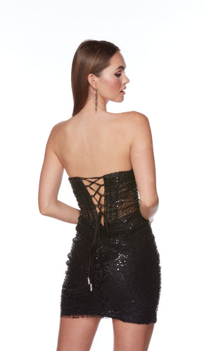 A chic sparkly sequin black short corset dress with a strapless straight across neckline. This dress is crafted from a gorgeous tulle-lace fabric and has a fitted silhouette that accentuates the curves.