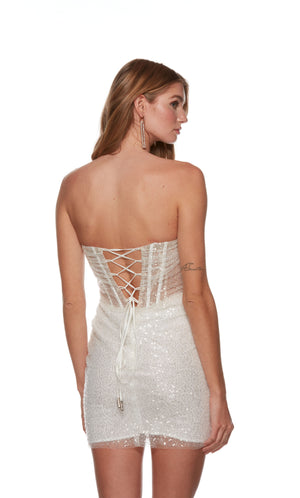 A chic sparkly sequin white short corset dress with a strapless straight across neckline. This dress is crafted from a gorgeous tulle-lace fabric and has a fitted silhouette that accentuates the curves.