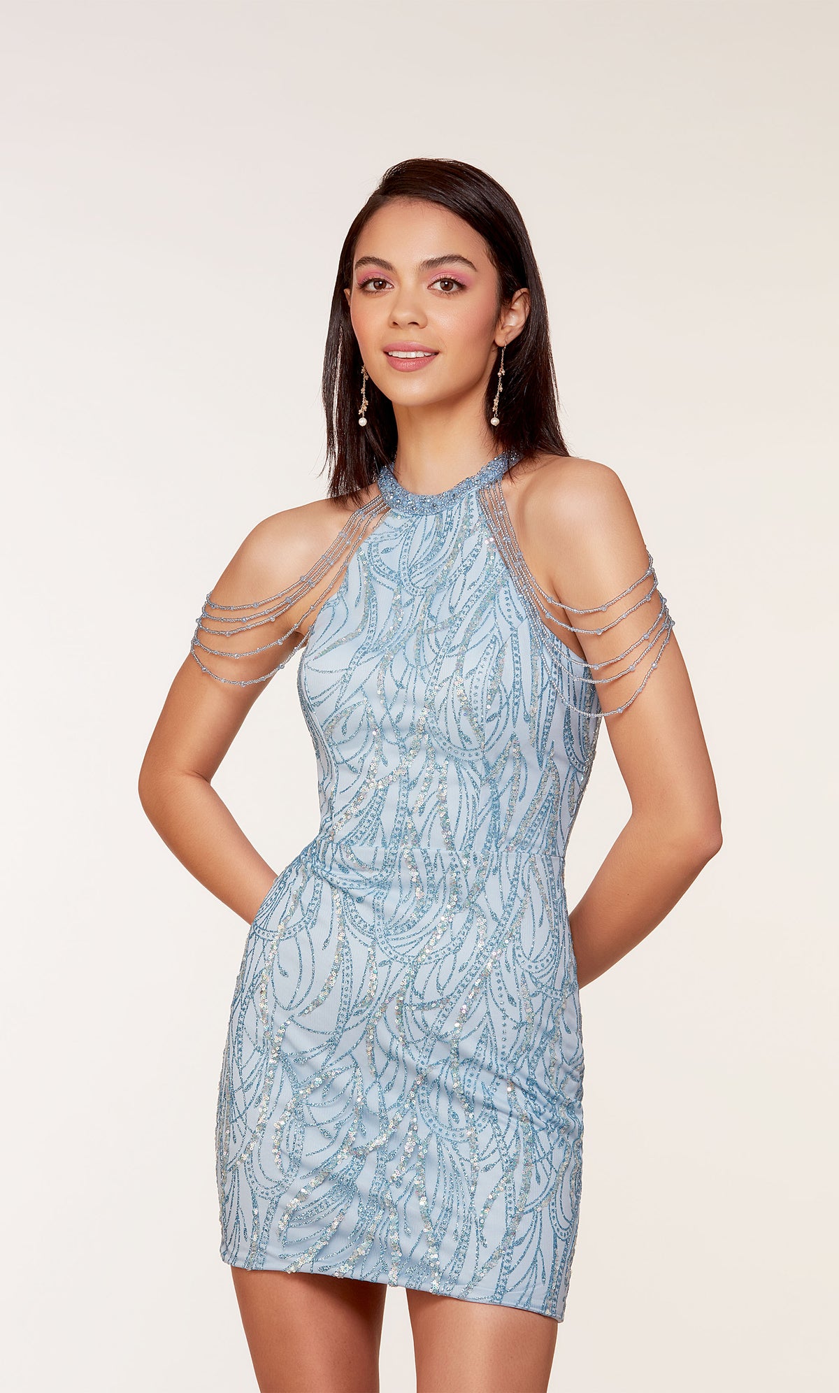 A unique short glacier blue dress featuring golden glitter embellishments, a high neckline, and hand-beaded accents.