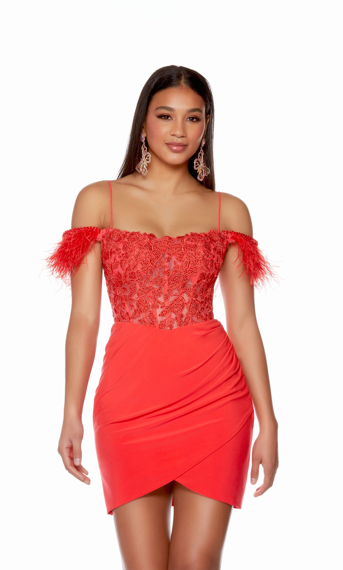 A spicy red corset dress with a sheer lace bodice, feather trim sleeves, and spaghetti straps. The skirt has a fun asymmetrical hem and is crafted from a stretchy, Jersey fabric.