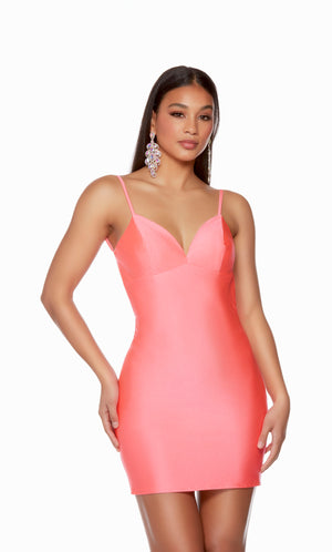 A playful, hyper-pink short homecoming dress with a V-neckline. The dress is crafted from a body con, Power Jersey fabric.