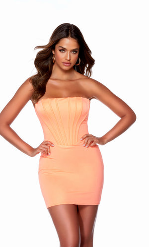 Wow in this short, neon-orange strapless corset dress by designer, ALYCE Paris. The dress was crafted from a body con, Metallic Jersey fabric. The look is finished off with a stylish lace-up back.  