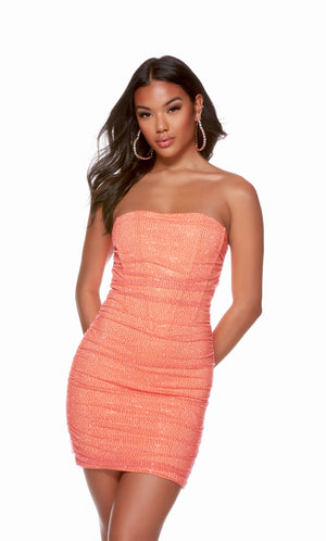 A fun, hot coral corset dress. The dress has a strapless neckline and a heat set stone embellished mesh overlay.