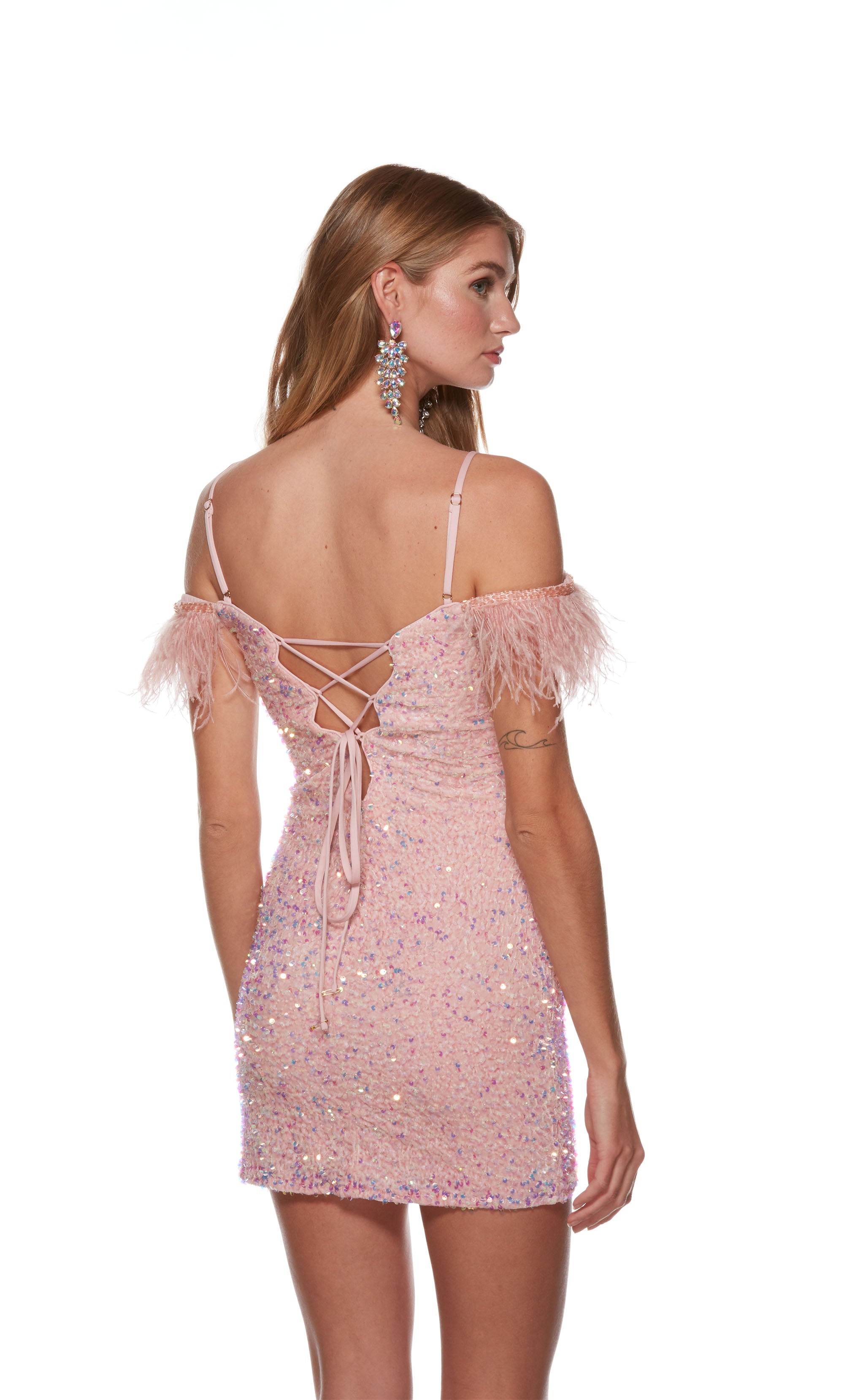 A sweet and sparkly fitted homecoming dress with an off-the-shoulder neckline with adjustable spaghetti straps. The dress highlights feather-trimmed sleeves and a lace-up back for a custom fit.