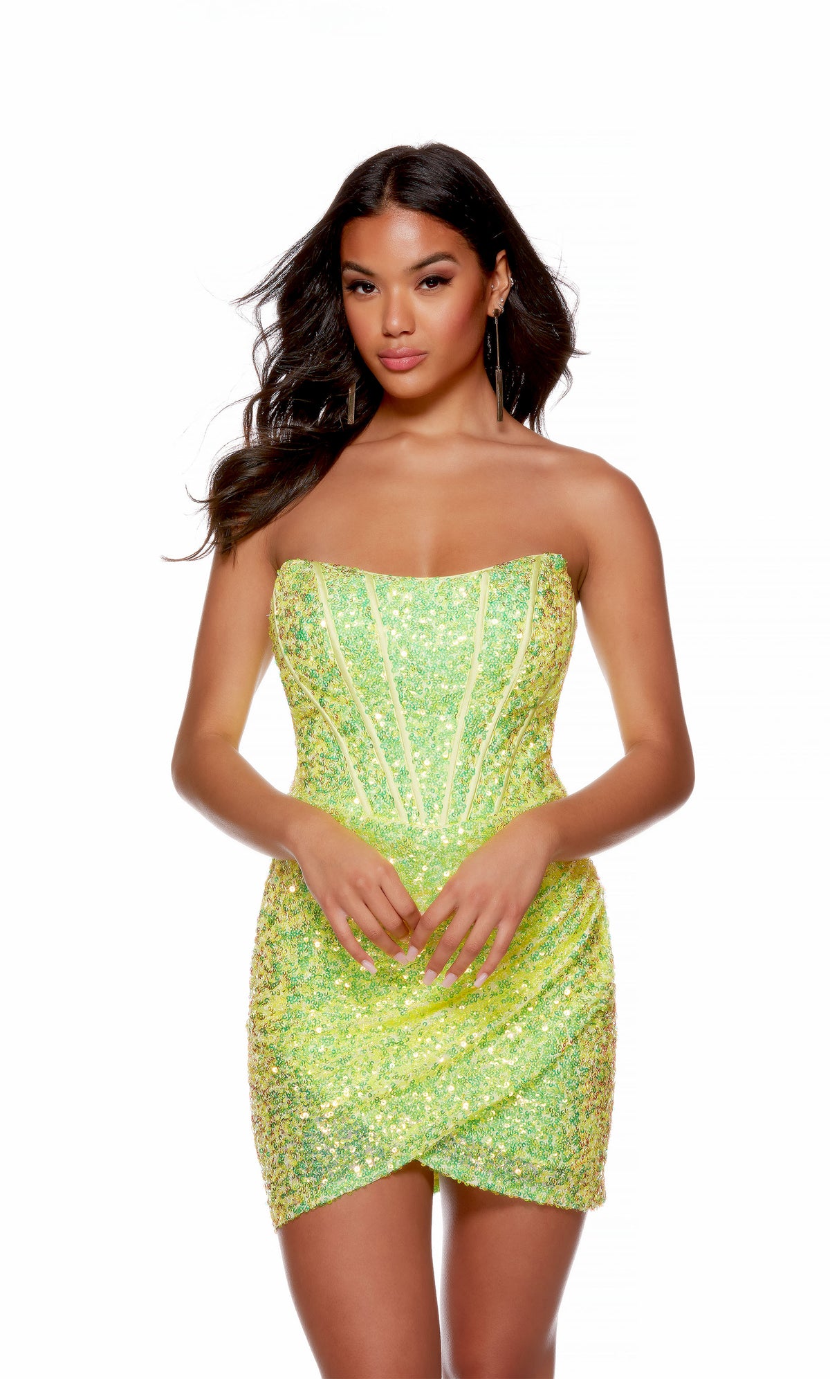 A glamorous neon green corset dress crafted from a sparkly, iridescent sequin fabric. The dress spotlights a chic strapless neckline, and a beautifully draped asymmetrical hemline.