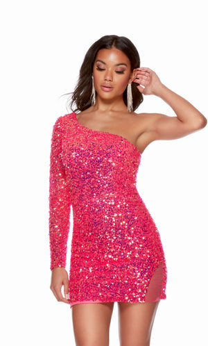 A glamorous, one-shoulder, iridescent sequin short designer dress with a zip-up back and fitted silhouette in the color barbie opal. The dress has a mesh illusion slit on the left side that adds a bit of fun to the finished look.